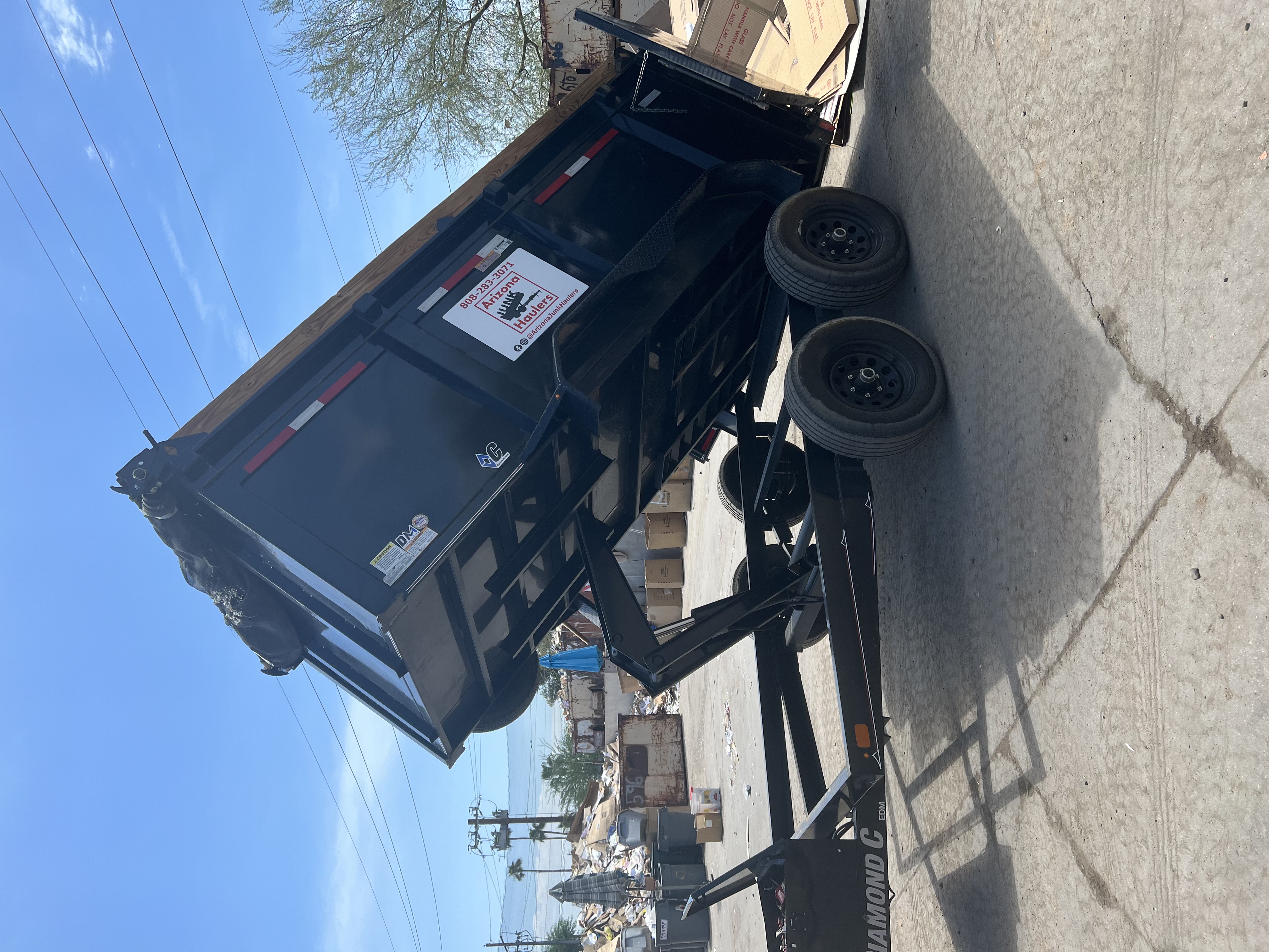 Trash Away dump trailer unloading debris at a recycling and transfer yard